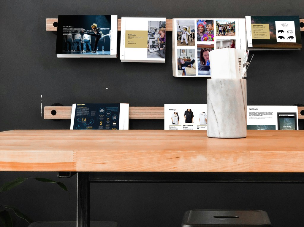 A series of pages appears to drape a wall. Each page is part of A&S' visual guidelines.