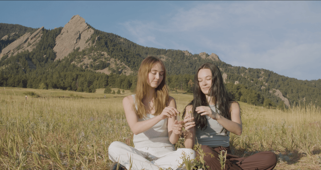 Two students capture Chautauqua air in glass vials.